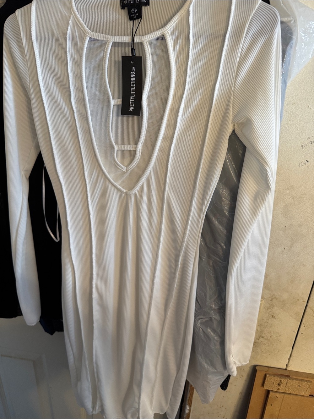 PrettyLittleThing White Ribbed Long Sleeve V-Cut Bodycon dress with thumb holes